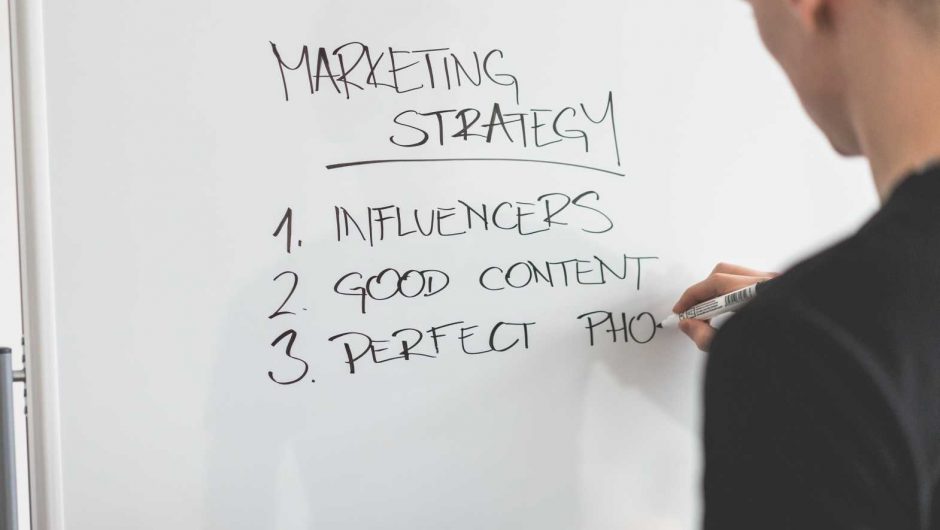 Marketing Expert Writing New Strategy on Whiteboard