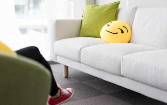 Colorful and Funny Pillows on Sofa in Modern Startup Office