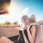Young Blonde Girl on Summer Ride in Convertible