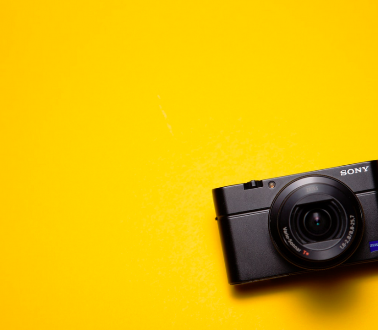 Black Sony Point-And-Shoot Camera on Yellow Surface