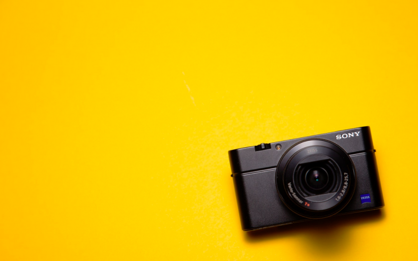 Black Sony Point-And-Shoot Camera on Yellow Surface